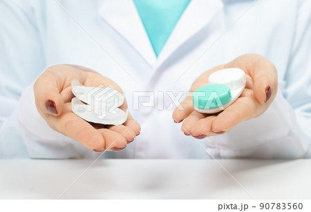 Daily Contact Lenses or reusable contact lenses. Eye doctor, Ophthalmologist offers choice of types contact lenses. Myopia and eyesight problem concept. Daily Contact Lenses or reusable contact lenses. Eye doctor, Ophthalmologist offers choice of types contact lenses. Myopia and eyesight problem concept. 90783560