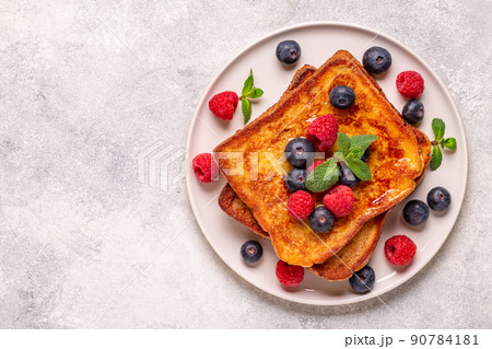 French toast with blueberries, raspberries, maple syrup 90784181