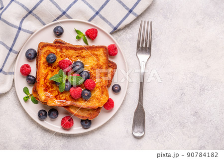 French toast with blueberries, raspberries, maple syrup 90784182