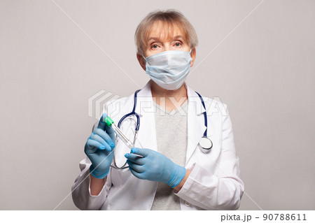 Medical worker in white uniform coat holding test tube 90788611