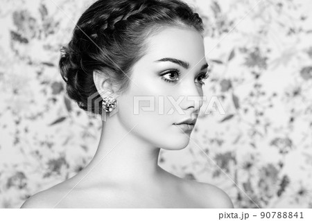 Portrait of young beautiful woman on a background of flowers Portrait of young beautiful woman on a background of flowers 90788841