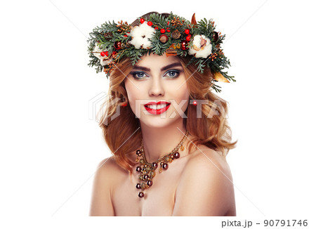 Portrait of beautiful young woman with Christmas wreath Portrait of beautiful young woman with Christmas wreath 90791746