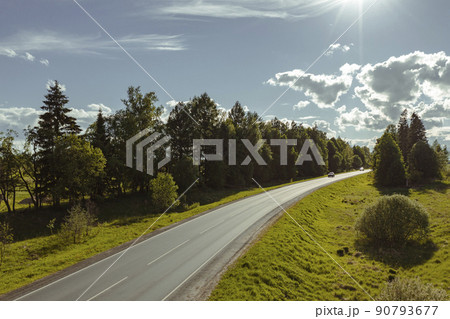 Asphalt road through green hills and clouds in the blue sky. High quality photo 90793677
