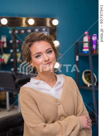 Girl with fashionable make-up and hairstyle smiling while looking at the camera. Girl with fashionable make-up and hairstyle smiling while looking at the camera. 90797941