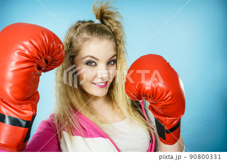 Funny girl in red gloves playing sports boxing Funny girl in red gloves playing sports boxing 90800331