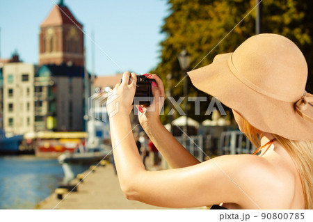 Beautiful elegant woman taking pictures with camera 90800785