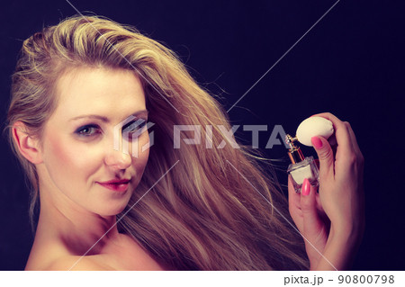 Beautiful woman with holding and applying perfume Beautiful woman with holding and applying perfume 90800798