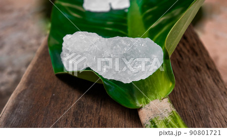 Crystal clear alum cubes or Potassium alum on green leaf. Chemical compound substance. Concept for beauty , spa and underarm treatment industrial. Crystal clear alum cubes or Potassium alum on green leaf. Chemical compound substance. Concept for beauty , spa and underarm treatment industrial. 90801721