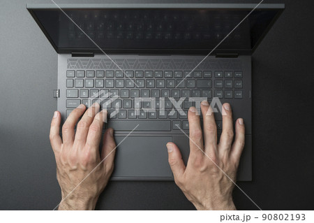 Laptop computer keyboard with user or gamer hands on black stylish background. Technology, business, internet concept. Laptop computer keyboard with user or gamer hands on black stylish background. Technology, business, internet concept. 90802193