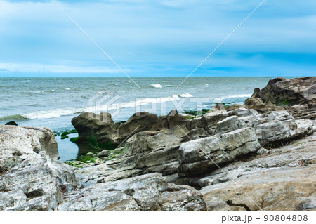 gently sloping rocky shore of the Caspian Sea with rounded rocks and algae on the stones gently sloping rocky shore of the Caspian Sea with rounded rocks and algae on the stones 90804808