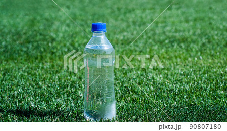water bottle on green grass for hydration, thirst water bottle on green grass for hydration, thirst 90807180