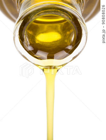 Oil pouring from a bottle Oil pouring from a bottle 90808026