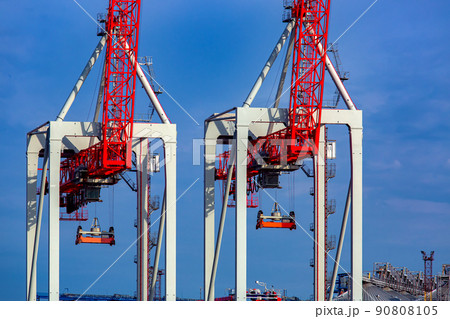 container cranes at shipyard big heavy technique for unloading containers on the background of blue sky, backdrop on industrial theme, nobody. 90808105
