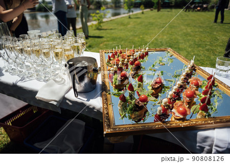 A wide variety of snacks on the table for guests. Shrimp, boiled pork, various types of meat and other products 90808126