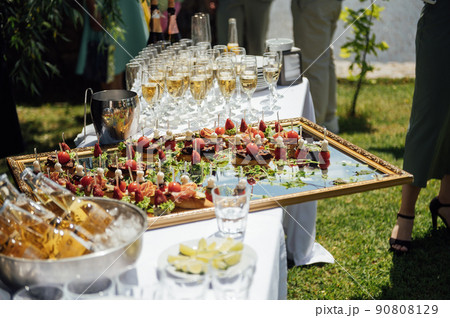 A wide variety of snacks on the table for guests. Shrimp, boiled pork, various types of meat and other products 90808129