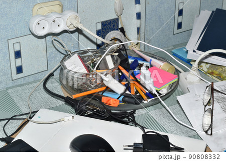 Work clutter on the table at home. 90808332