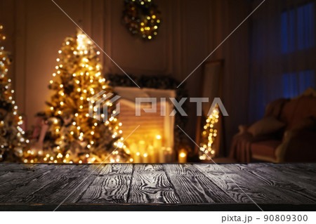 Empty wooden surface and blurred view of room decorated for Christmas 90809300