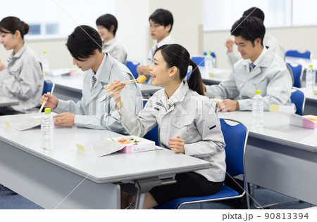 会議室でお弁当を食べる作業着の男女 会議室でお弁当を食べる作業着の男女 90813394