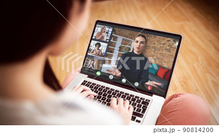 Woman attending online meeting with multiracial colleagues on laptop while working from home Woman attending online meeting with multiracial colleagues on laptop while working from home 90814200
