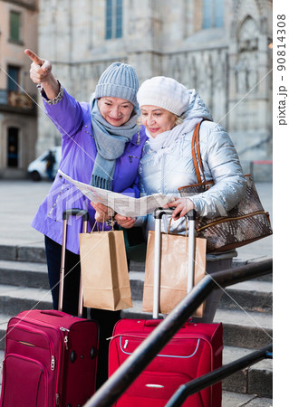 Senior females traveling with city map Senior females traveling with city map 90814308