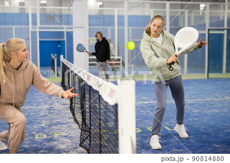 Teenage girl and adult woman in padel court Teenage girl and adult woman in padel court 90814880