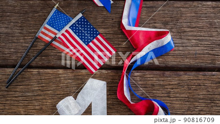 Two miniature american flags and ribbons on wooden surface with copy space 90816709