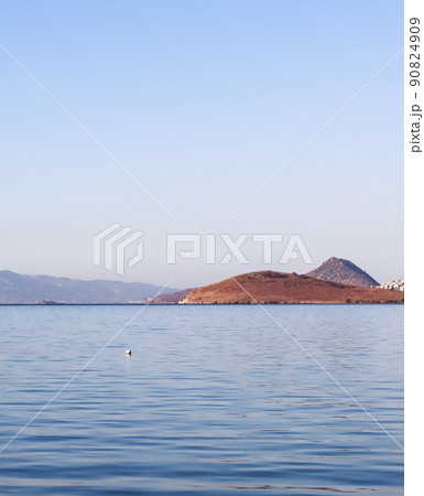Blue sea, a boat, islands and mountains. Tranquil seascape and coastal nature background 90824909