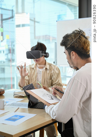 Website development team testing virtual reality headset, brainstorming on augmented reality improvement, future technology for business Website development team testing virtual reality headset, brainstorming on augmented reality improvement, future technology for business 90826390