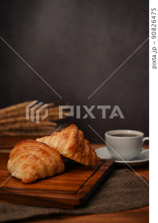 Homemade butter croissant in tray decorated with wheat on wooden table. Levitation, bread bakery products cafe concept Homemade butter croissant in tray decorated with wheat on wooden table. Levitation, bread bakery products cafe concept 90826475