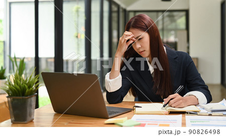 Tired female employee woman having headache, stress, hard work and insufficient rest 90826498