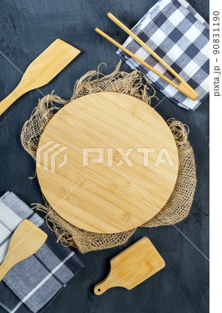 Wooden dish board on black table, top view, food menu card or recipes background concept, Eco friendly wooden kitchenware. Copy space. Vertical photo Wooden dish board on black table, top view, food menu card or recipes background concept, Eco friendly wooden kitchenware. Copy space. Vertical photo 90831190