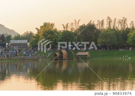 Pavilion houses in pond or lake in garden park in urban city town. 90833974