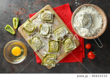 Concept of cooking ravioli on dark background 90834250