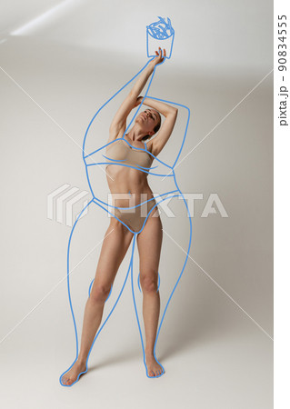 Portrait of slim woman in underwear wear posing isolated over gray studio background. Lines around body before losing weight. Portrait of slim woman in underwear wear posing isolated over gray studio background. Lines around body before losing weight. 90834555