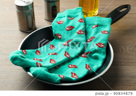 Cooking concept with socks with meat slices on wooden background Cooking concept with socks with meat slices on wooden background 90834879
