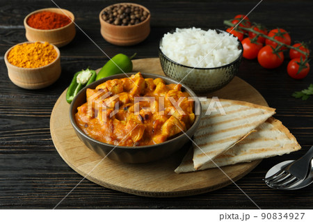 Concept of tasty food with chicken tikka on wooden background Concept of tasty food with chicken tikka on wooden background 90834927