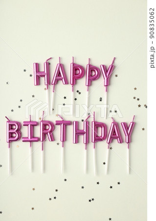 Happy birthday candles and glitter on white background Happy birthday candles and glitter on white background 90835062
