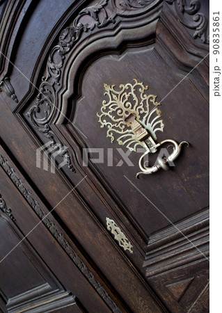 Wooden door of an old French mansion 90835861