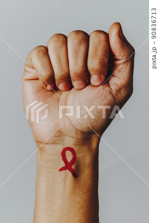 AIDS red awareness ribbon painted in his wrist AIDS red awareness ribbon painted in his wrist 90836713