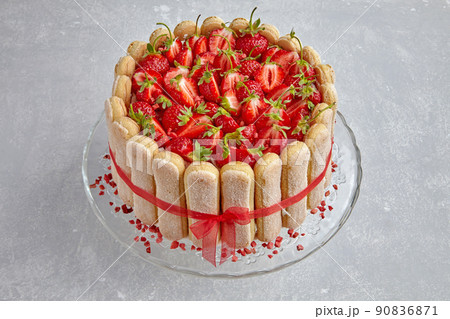 Cake with strawberries, savoiardi cookies and mascarpone tied with a red ribbon 90836871