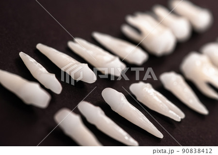 Prosthetic dentistry White teeth on black background Oral dental hygiene Dental health concept Oral care teeth restoration top view. Prosthetic dentistry White teeth on black background Oral dental hygiene Dental health concept Oral care teeth restoration top view. 90838412