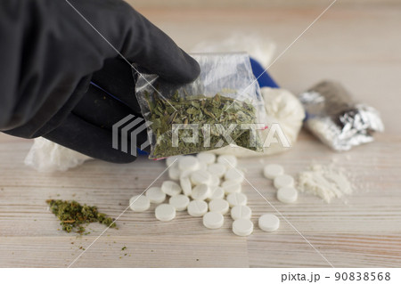 cocaine, heroin, spice, marijuana and etc - lots of unknown pills, white powder in a transparent package and the foil and similar to the "spice" mixture, hand in a black glove holding a single package cocaine, heroin, spice, marijuana and etc - lots of unknown pills, white powder in a transparent package and the foil and similar to the "spice" mixture, hand in a black glove holding a single package 90838568