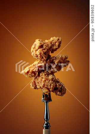 Fried chicken on a fork. 90839602