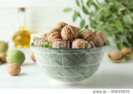 Concept of healthy food with walnuts on white wooden background Concept of healthy food with walnuts on white wooden background 90839850