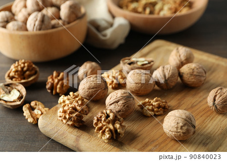 Concept of healthy food with walnuts on wooden background 90840023