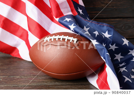 American football ball and American flag on wooden background American football ball and American flag on wooden background 90840037