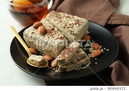 Concept of tasty food with halva on white textured background Concept of tasty food with halva on white textured background 90840325