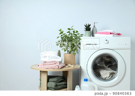 Concept of housework with washing machine on white background Concept of housework with washing machine on white background 90840363