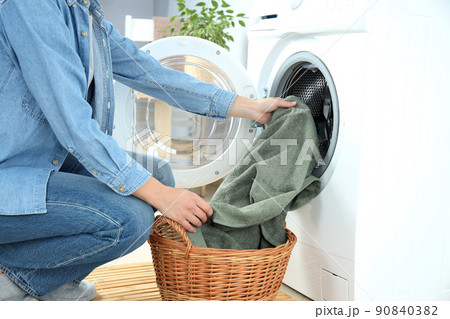 Concept of housework with washing machine and girl on white background 90840382