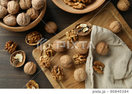 Concept of healthy food with walnuts on wooden background 90840384